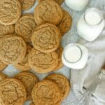 Sot Cookie Butter Cookie on top of each other with 3 milk bottle glass and whisk off to the side