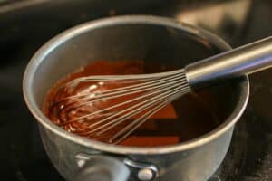 Whisk in a sauce pot with dark chocolate, nutella, cream and gelatin.