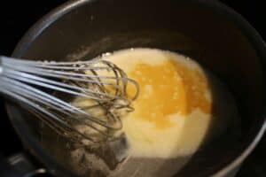 Whisk in a sauce pot with vanilla and sweetned condensed milk in the water, sugar, corn syrup mixture