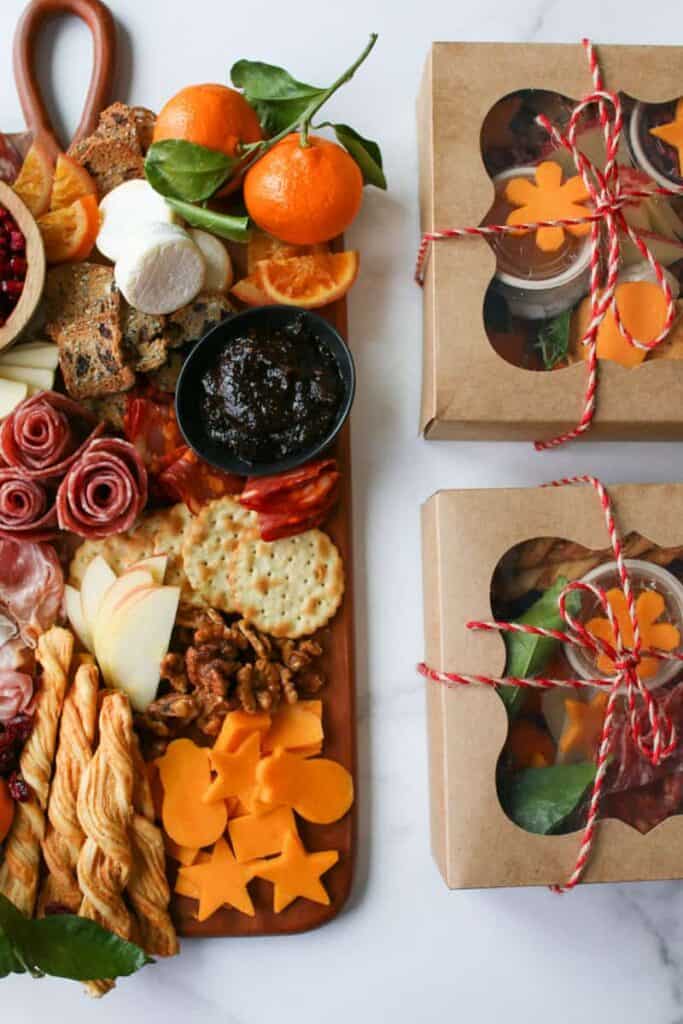 overhead of half of the Trader Joe's Winter Cheese & Charcuterie Board and the half of 2 grazing boxes