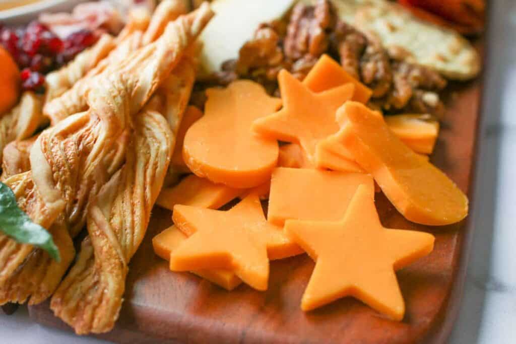 Close up of sliced and cut out cheddar cheese on the trader joes cheese & charcuterie board