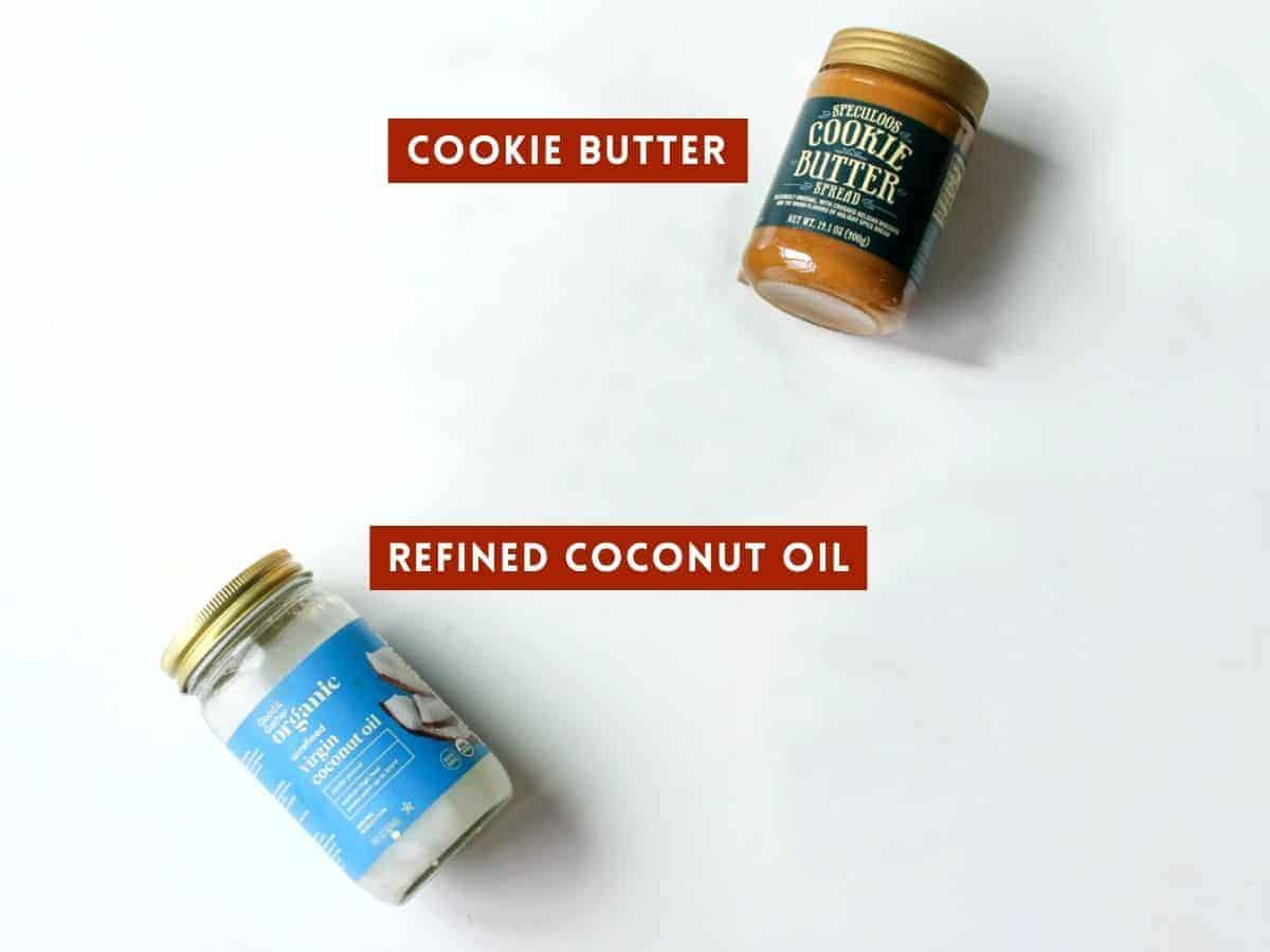 A jar of cookie butter and a jar of coconut oil. Each is labeled with a dark red box with white text in all caps.