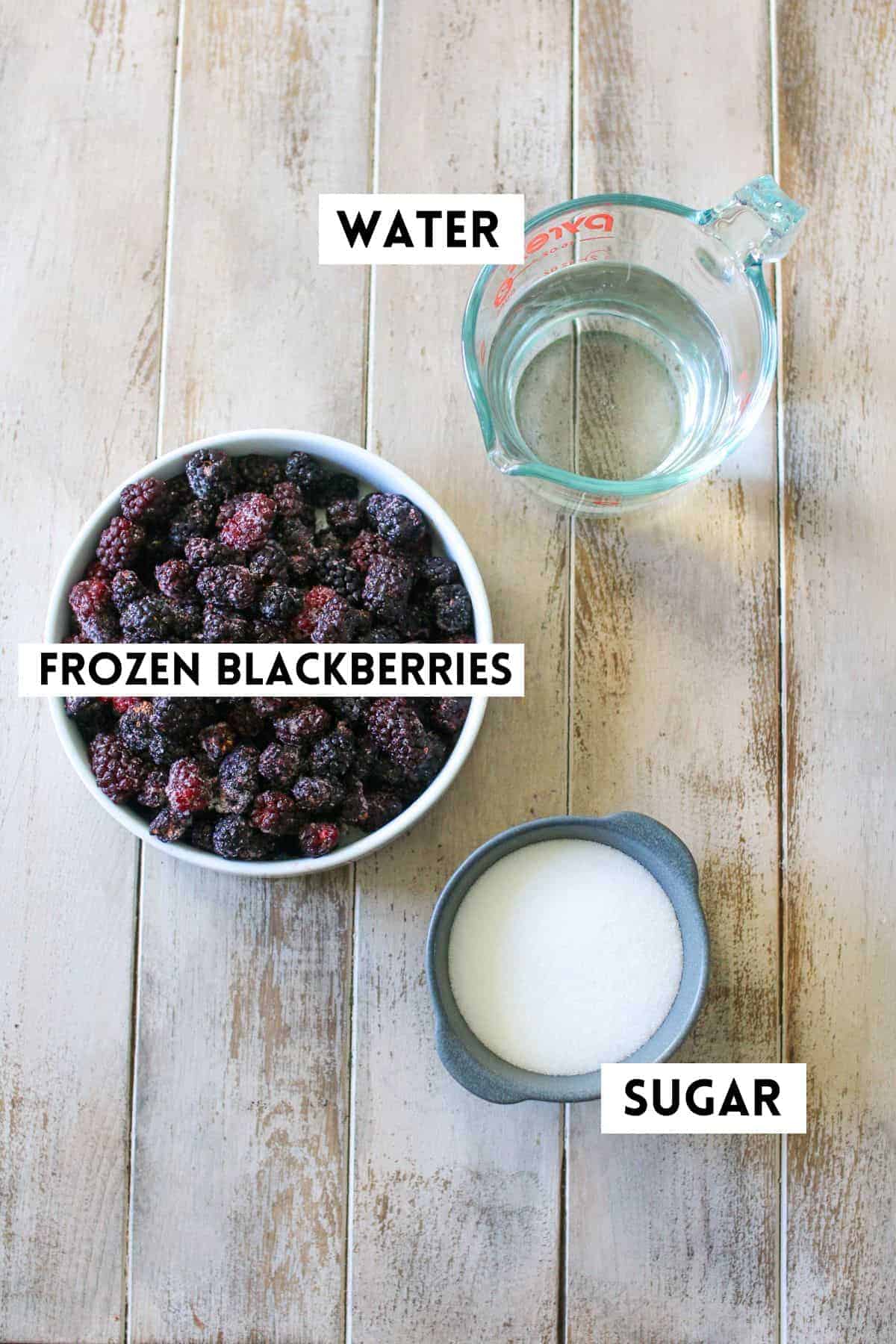 Blackberry Popsicle Ingredients on a wood plank background. Each item is labeled with a white rectangle with black text in all caps.