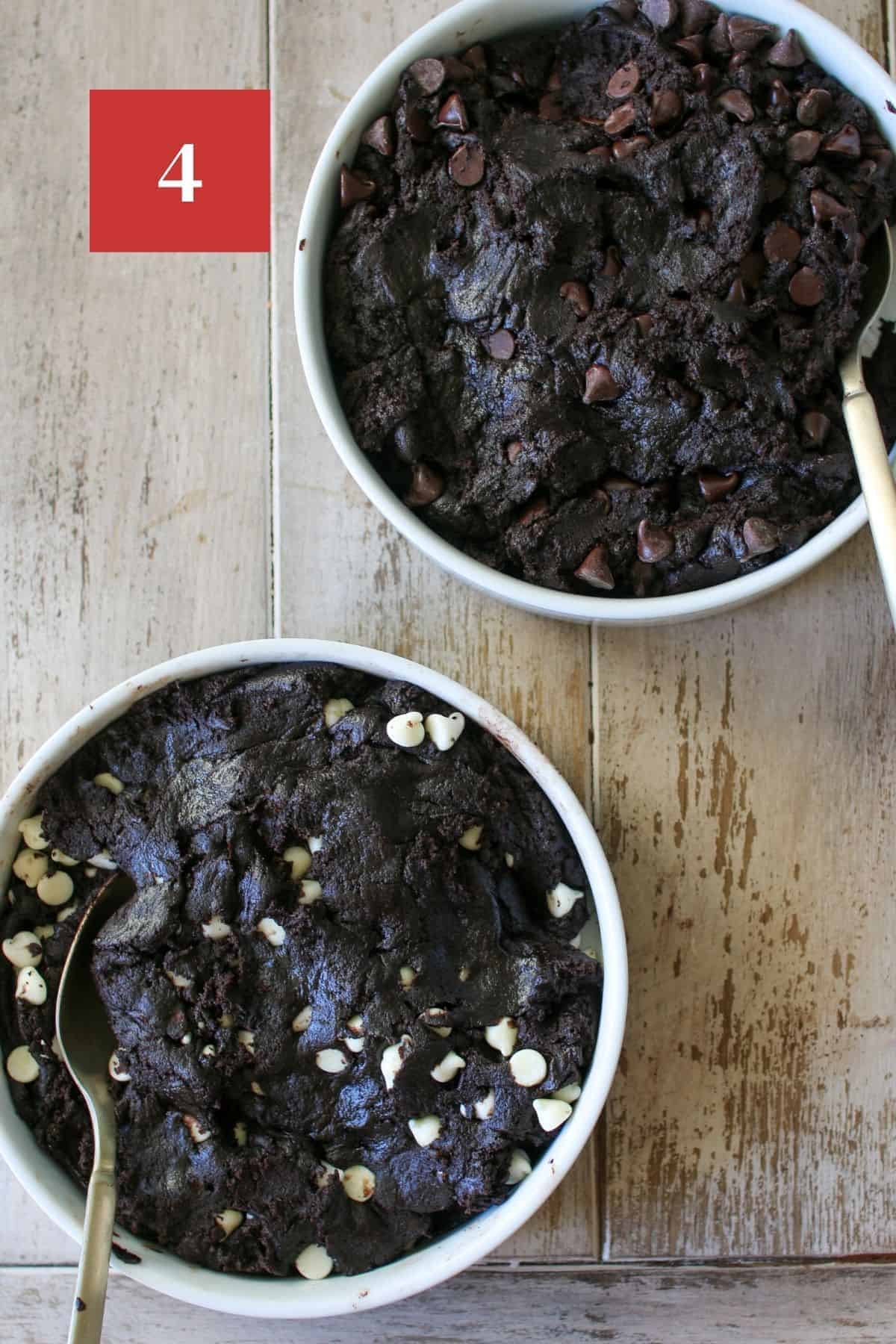 2 white bowls of dark chocolate cookie dough. One dough with white chocolate chips and one dough with semi-sweet chocolate chips. Each bowl has a gold spoon in it and the bowls are on a wood plank background.  In the upper left corner is a dark red square with a white '4' in the center.