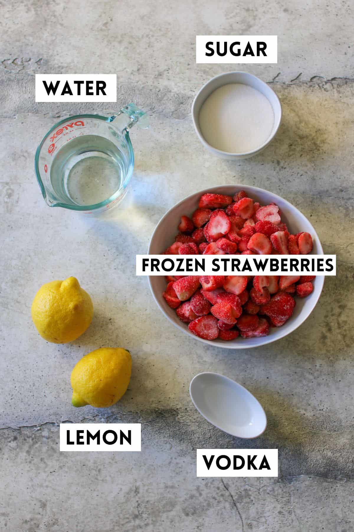 Strawberry Lemonade Sorbet ingredients on a stone background. Each ingredient is labeled with a white rectangle box with black font in all caps.