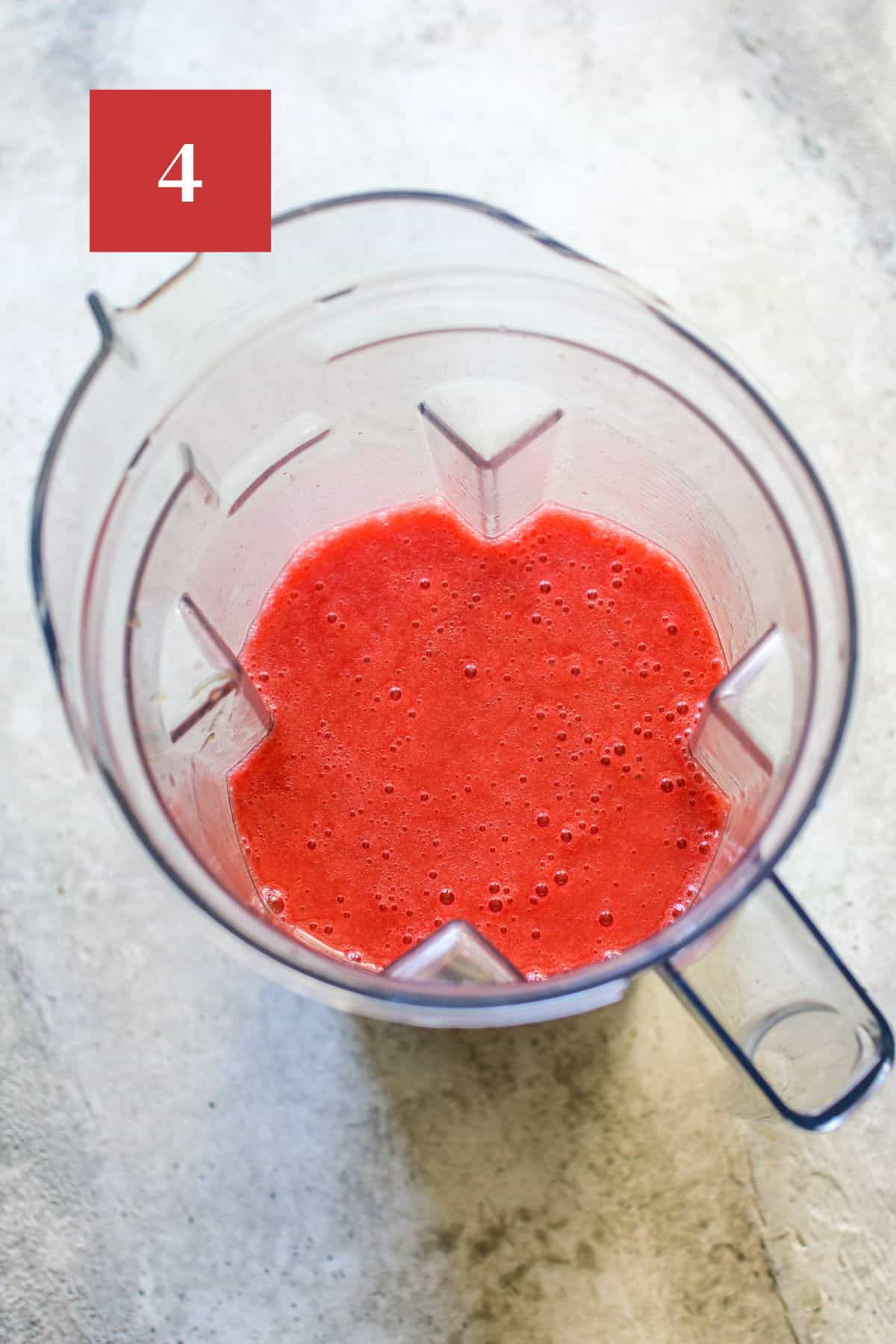 Strawberry Lemonade Sorbet Base in a blender body on a stone background. In the upper left corner is a dark red square with a white '4' in the center.