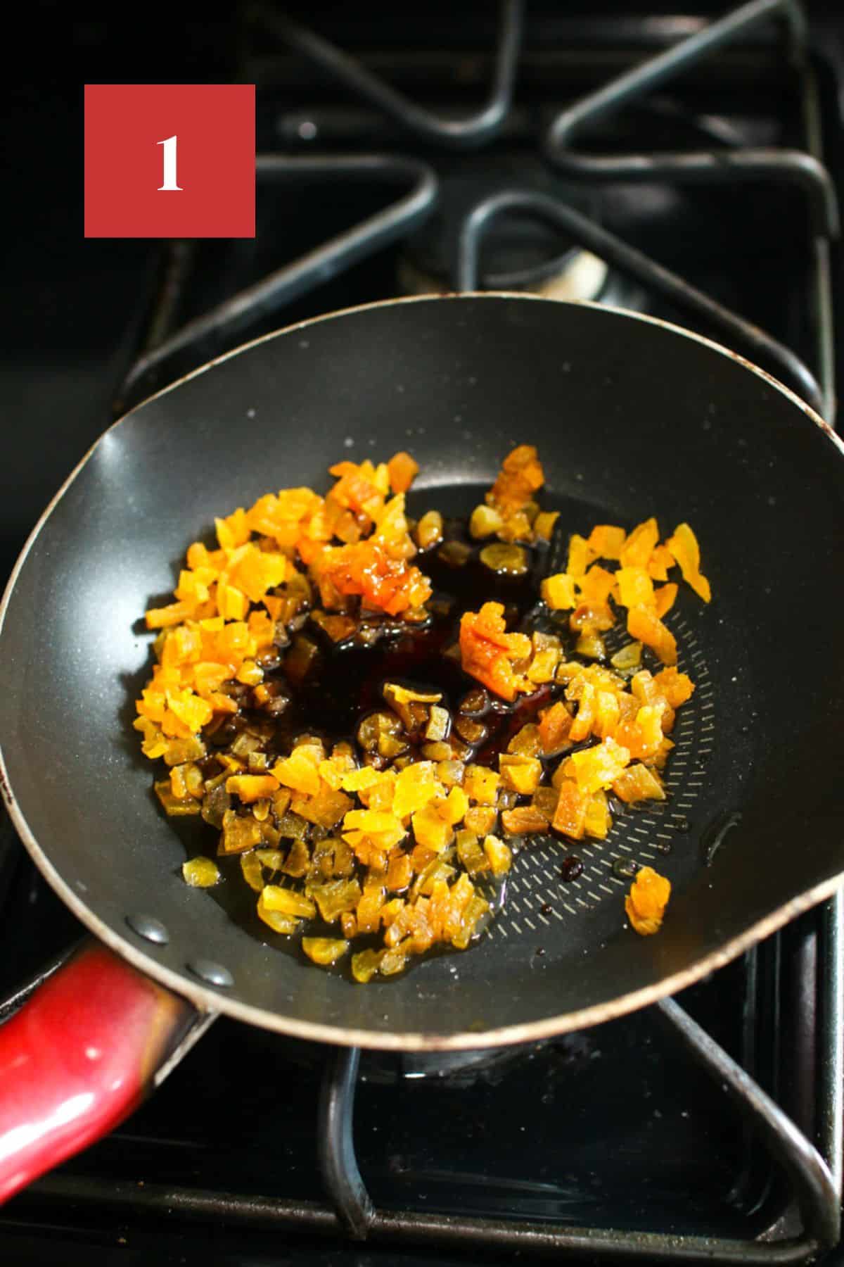 A small pan on a gas stove top. In the ban is small diced apricots, balsamic vinegar, and other ingredients. In the upper left corner is a dark red square with a white '1' in the center.